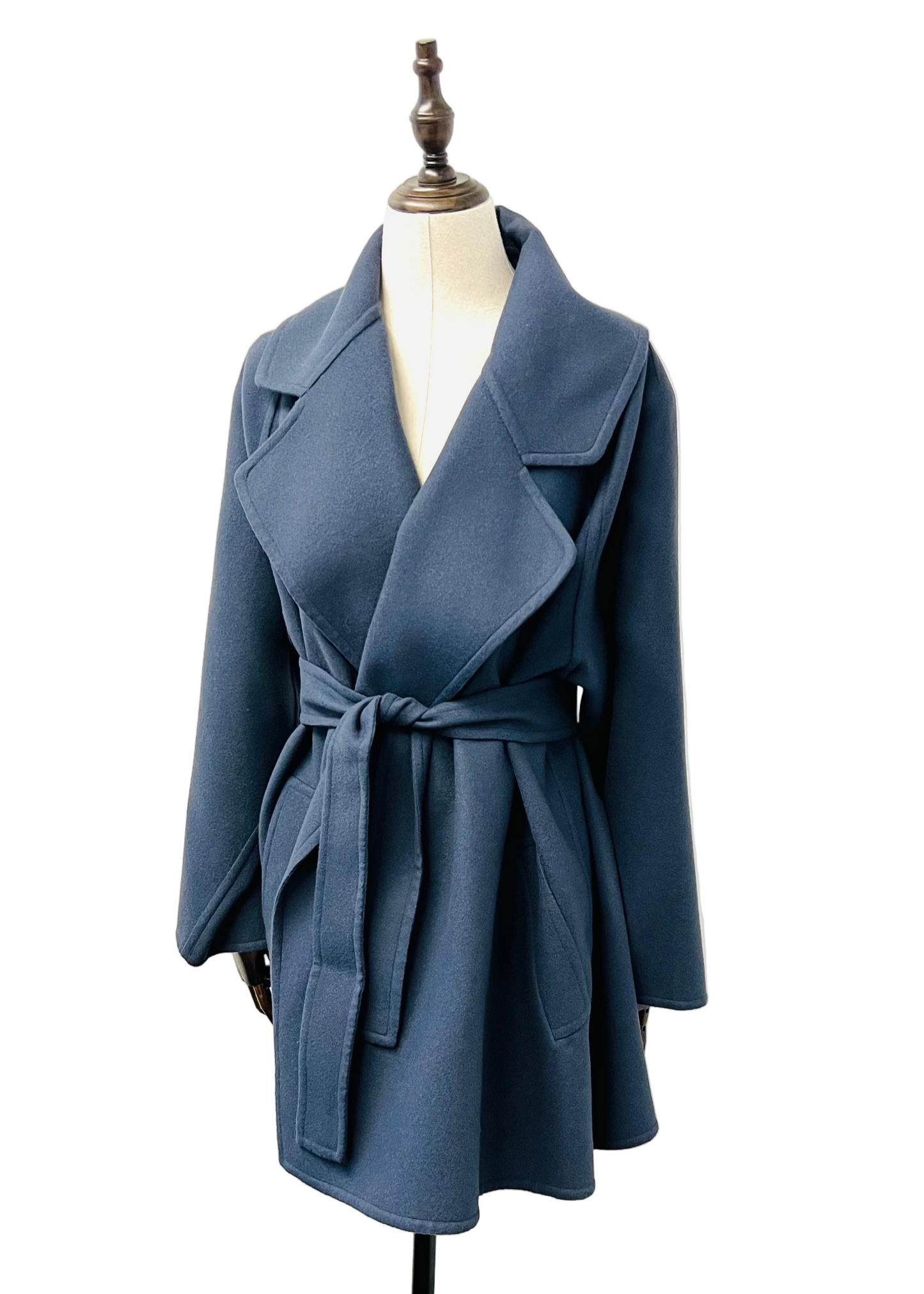 Blue coat on a mannequin against a white background