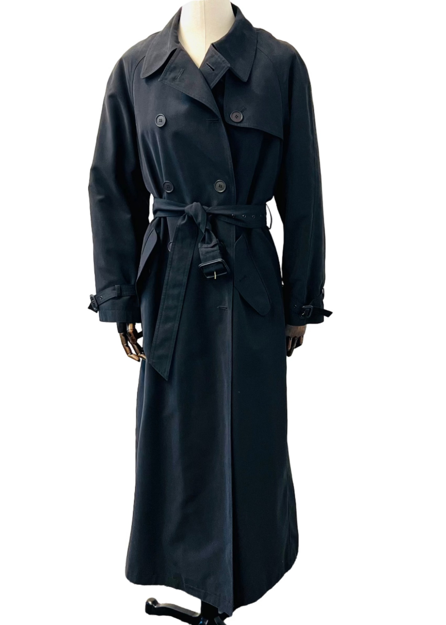 A black trench coat with a belt, displayed on a mannequin against a white background.