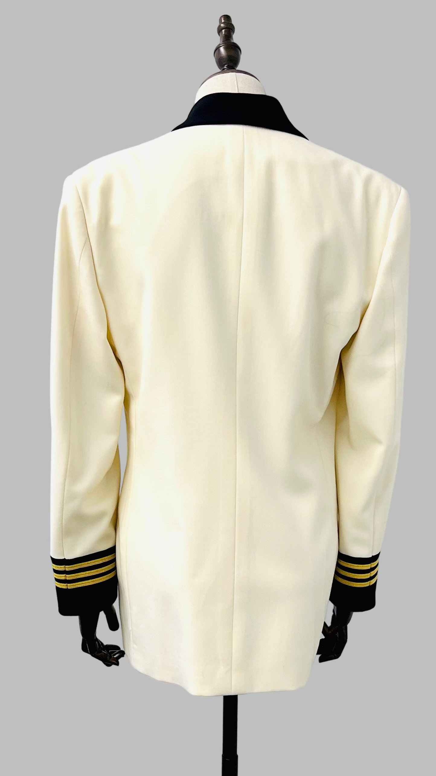 White uniform jacket with black cuffs on a mannequin against a white background