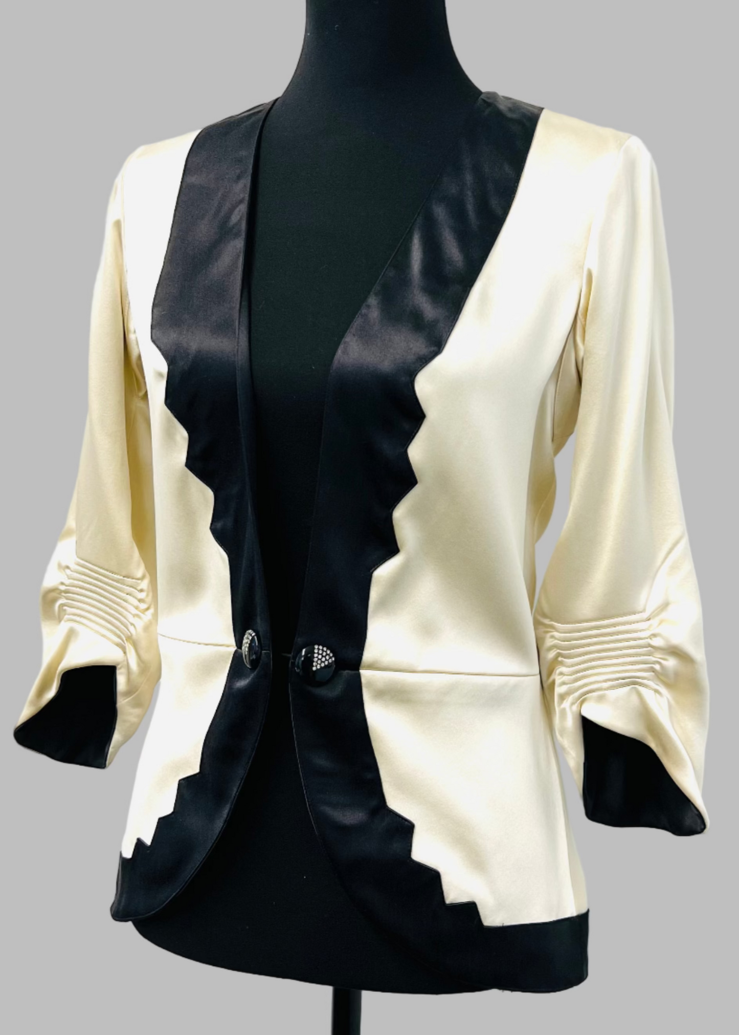 Black and white jacket on a mannequin against a white background