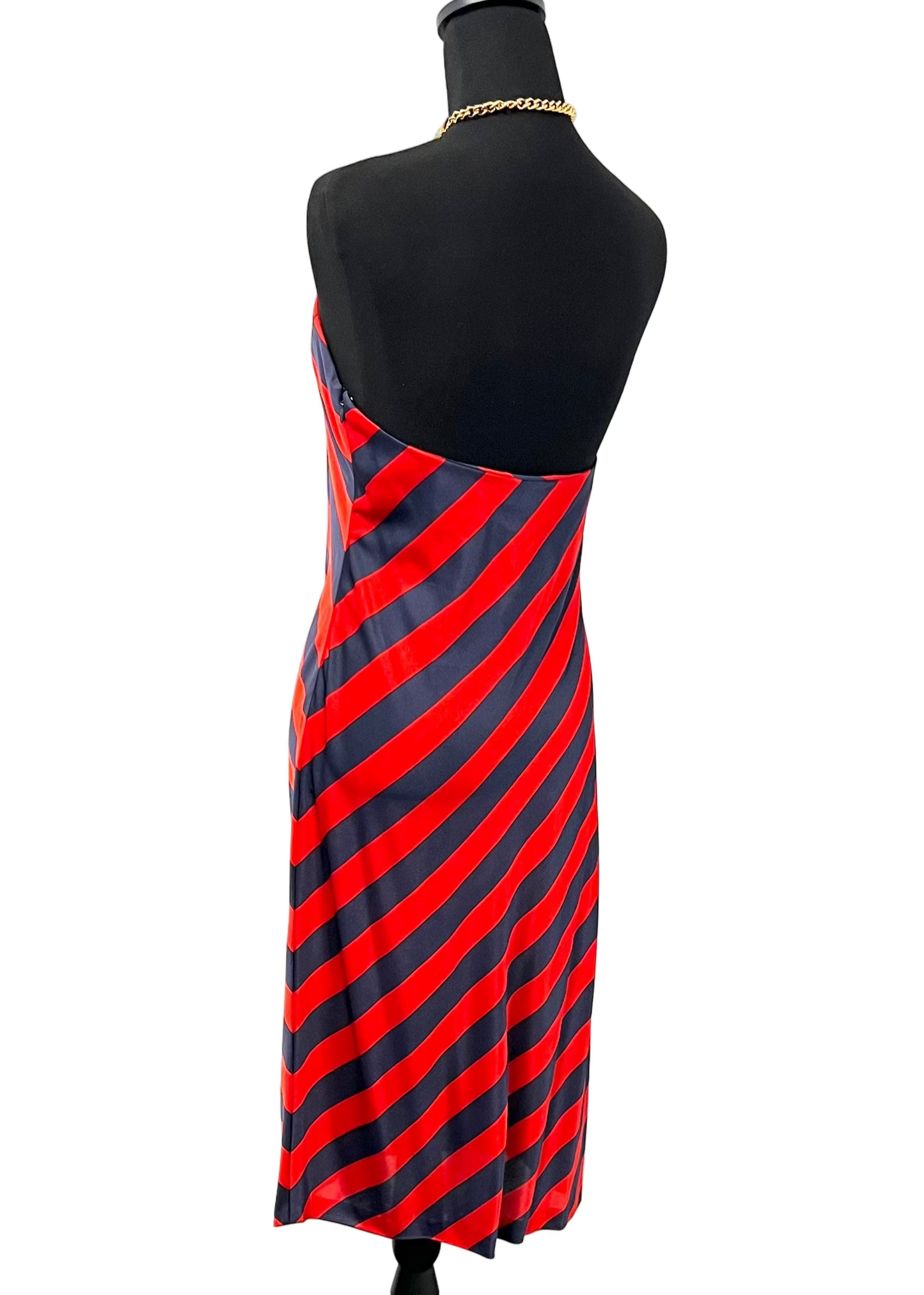 Mannequin wearing a red and navy striped dress on a white background